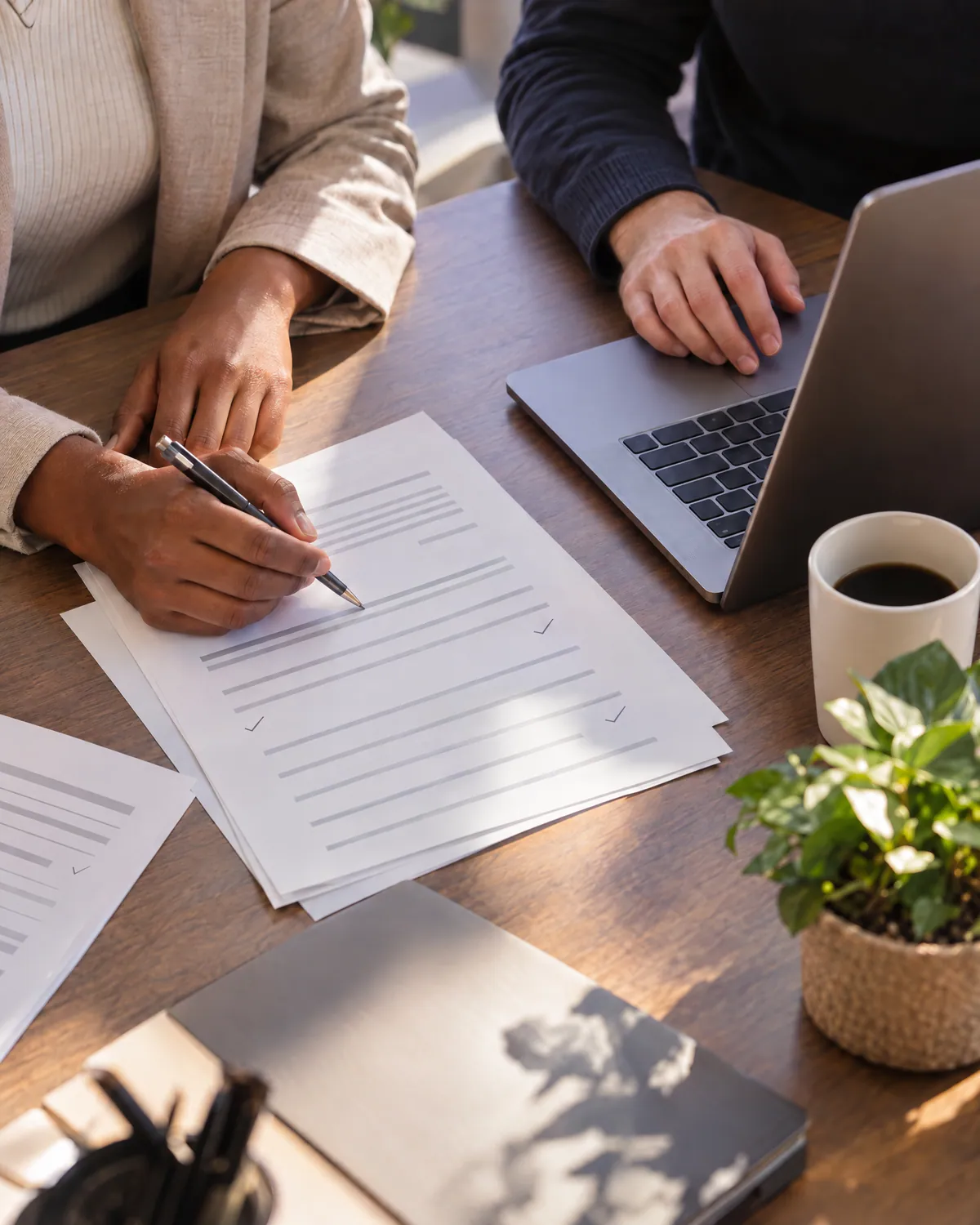 Two people review a merchant application at a table